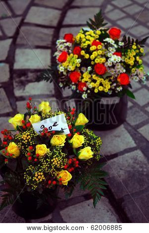 Bouquets of roses and other flowers on farmers market in Perigueux, France