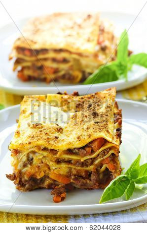 Two servings of fresh baked lasagna on plates