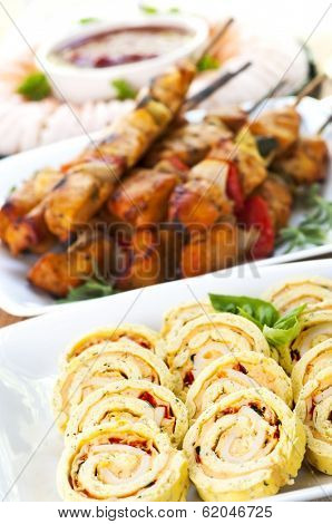 Many dishes of bite size appetizers and party food