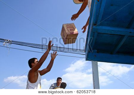 Man Is Loading The Ferry By Throwing Goods