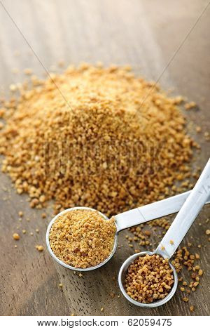 Organic coconut palm sugar in measuring spoons