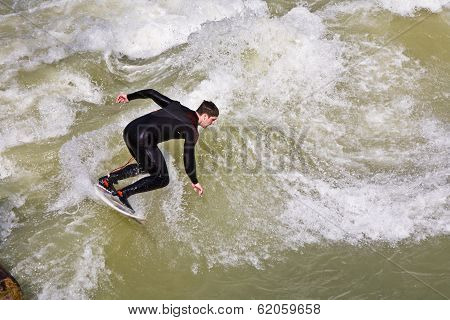 Surfer Surfs At The Isar In Huge Waves For Season Opening Event At The Wittelsbacher Bridge