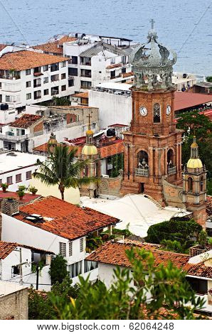 Cityscape view from above with church and Pacific ocean in Puerto Vallarta, Mexico