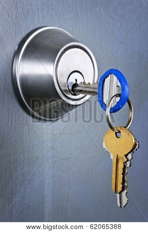 Keys inserted in door lock close up