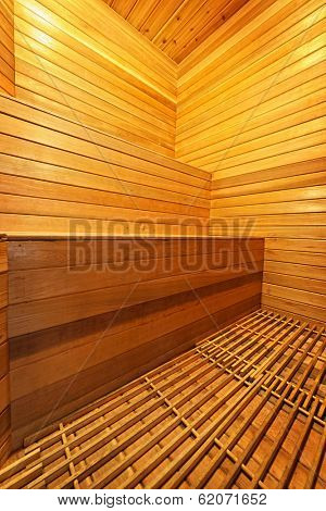 Finnish home sauna interior with wooden bench walls and floor
