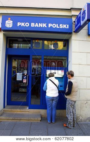 KRAKOW, POLAND, 25 OCTOBER 2003 -- A customer withdraws money from a Bank PKO BP automated teller cash machine. Bank PKO is one of Poland's leading financial institutions.