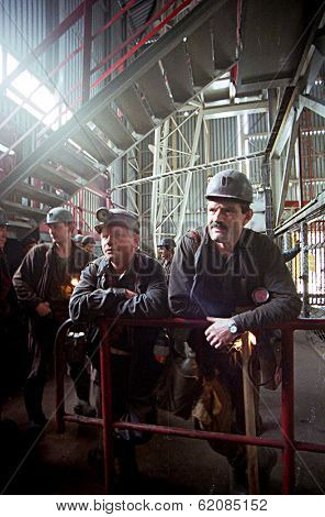 KATOWICE - MAY 16:  Coal miners from the Katowice  II (KWK) coal mine await the elevator that will take them 1800 feet below the earth in Katowice, Poland, on May 16, 2001.