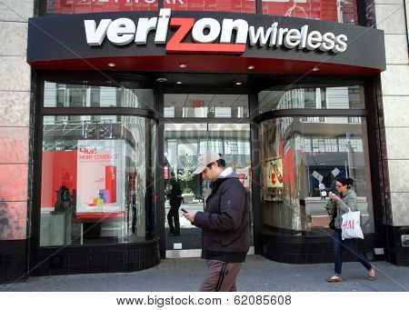 NEW YORK CITY - APRIL 19: People walk past a Verizon Wireless retail outlet in New York City, on Friday, April 19, 2013.