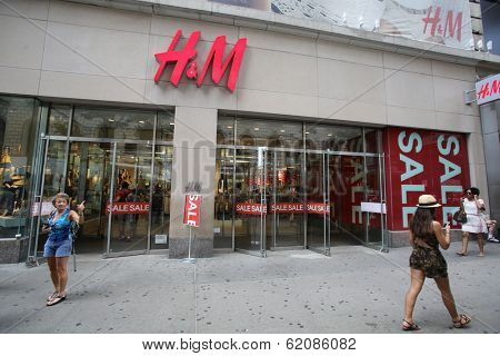 NEW YORK CITY - JULY 8: Shoppers walk past a H&M retail clothing store in New York City, New York, on Monday, July 8, 2013. H & M Hennes & Mauritz AB is a Swedish company.