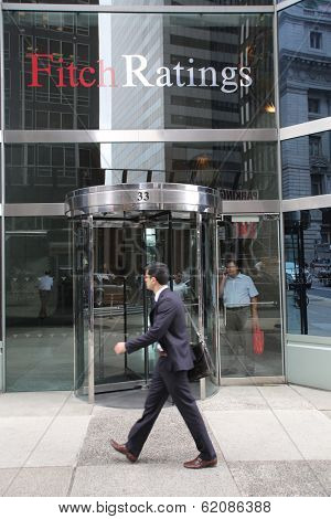 NEW YORK CITY - JULY 11: Pedestrians walk past the headquarters of Fitch Ratings in lower Manhattan on Thursday, July 11, 2013. Fitch Group is a jointly owned by Hearst Corporation and FIMALAC SA