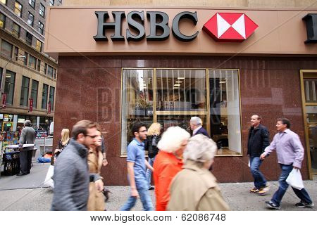 NEW YORK CITY - OCT 23 2013: Pedestrians walk past a HSBC bank branch in Manhattan on Wednesday, October 23, 2013. HSBC Holdings plc is a British multinational banking and financial services company