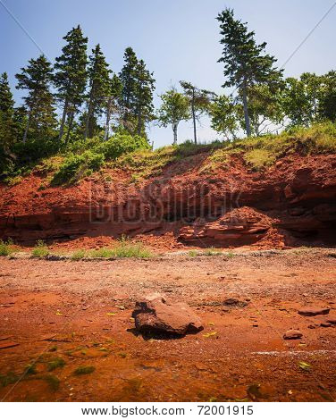 Red beach and cliffs of Prince Edward Island Atlantic coast near Cavendish, PEI, Canada.