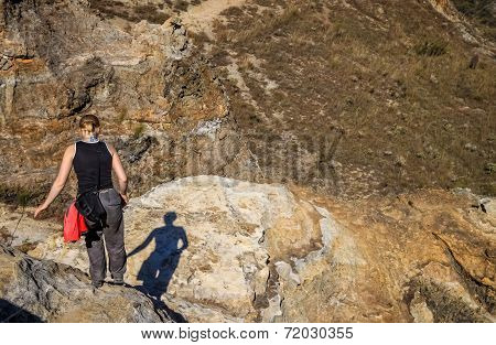 Woman trekking on rocky trail