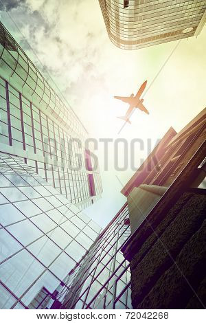 plane flying over highrise office buildings seen from below, Frankfurt am Main, Germany