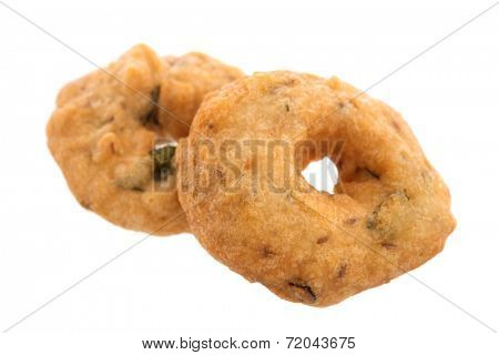 Vadai is a savoury snack from South India, very common street food in the Indian Subcontinent and Sri Lanka, shoot isolated on white background.