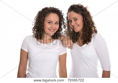 Real twin sisters: Portrait of two smiling isolated young woman with natural curls.