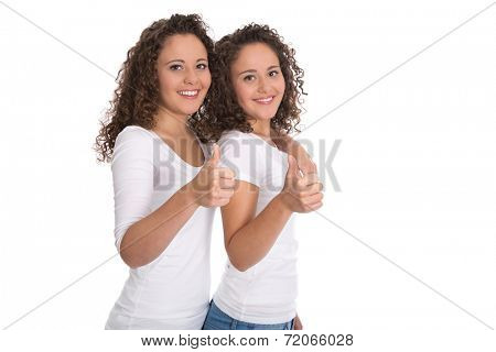 Smiling isolated girls with thumbs up: real twins sisters.
