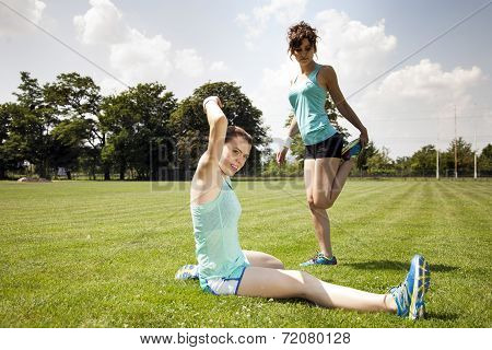 Two Young Girls Stetching Before A Jogging
