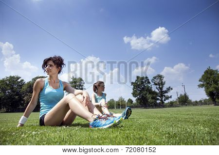 Two Young Girls Stetching Before A Jogging