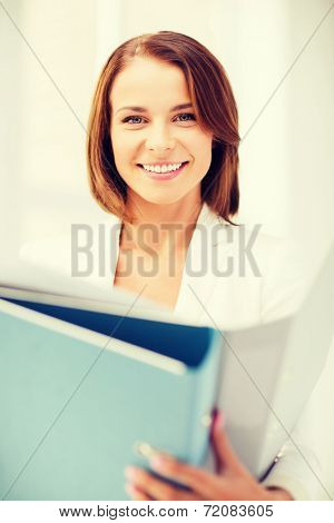 business concept - businesswoman with folders in office