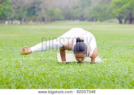 Beautiful Woman Practicing Yoga In The Park