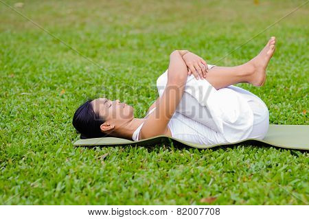 Beautiful Woman Practicing Yoga In The Park