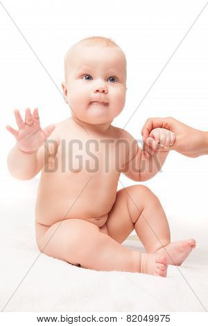 small child sits, hand helping him