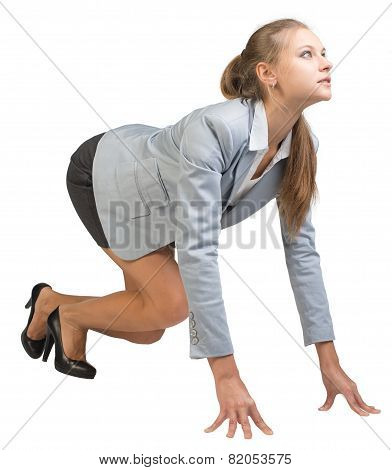 Businesswoman standing in running start pose