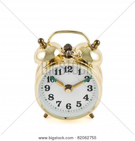 Golden mechanical alarm clock isolated