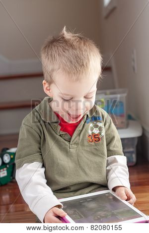 little boy playing with tablet