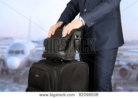 Young Businessman  In  A Modern  Stylish Suit With  Luggage In  The Airport