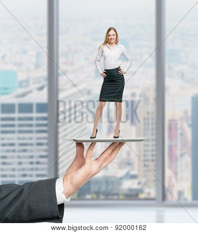 Businessman's Hand Is Holding A Gadget With Standing Beautiful Employee On It. Human Recourses Conce