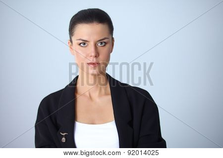 A young woman standing, isolated on graybackground