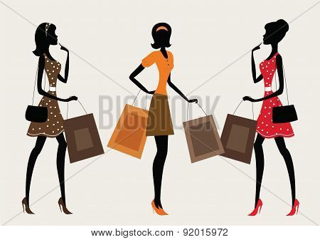 Three silhouettes of a women shopping.