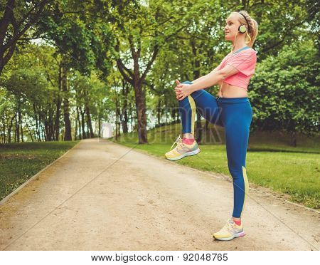 Woman doing stretching exercise before running 