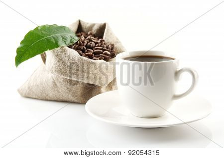 Sack Full Of Coffee Beans With Green Leaf And Coffee Cup