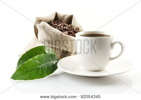 Sack Full Of Coffee Beans With Green Leaf And Coffee Cup