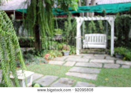 Blur Garden With White Swing Seat