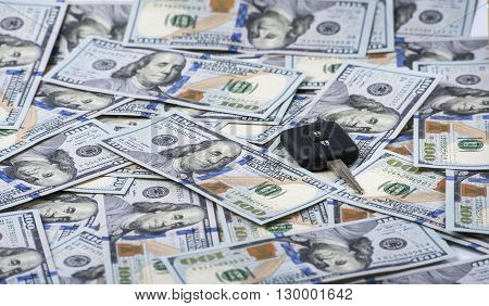 Car key on the background of one hundred dollar bills