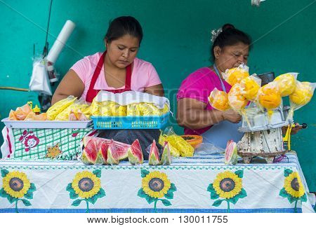 PANCHIMALCO EL SALVADOR - MAY 08 : A Salvadorian women sells fruits during the Flower & Palm Festival in Panchimalco El Salvador on May 08 2016