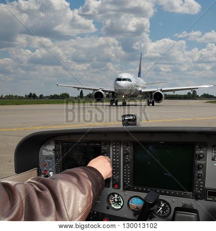 Kiev Ukraine - November 12 2010: Pilot is performing the pre-flight preparations in the cockpit of a light plane