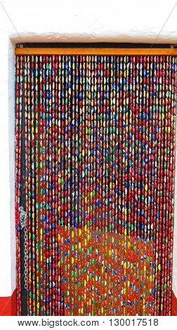 Alora Spain 23 April 2016: Close-up of colourful Bottle top curtain. Alora Spain 23 April 2016