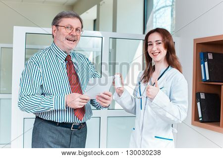 The patient and his doctor in medical office. Healthcare concept