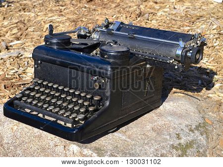 An old black carriage typewriter with a ribbon is pre-computer days
