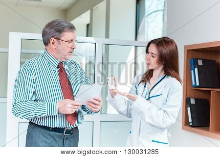 The patient and his doctor in medical office. Healthcare concept
