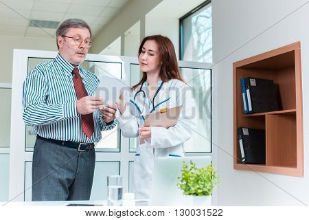 The patient and his doctor in medical office. Healthcare concept