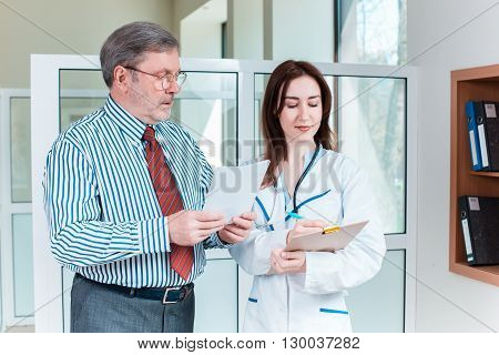 The patient and his doctor in medical office. Healthcare concept