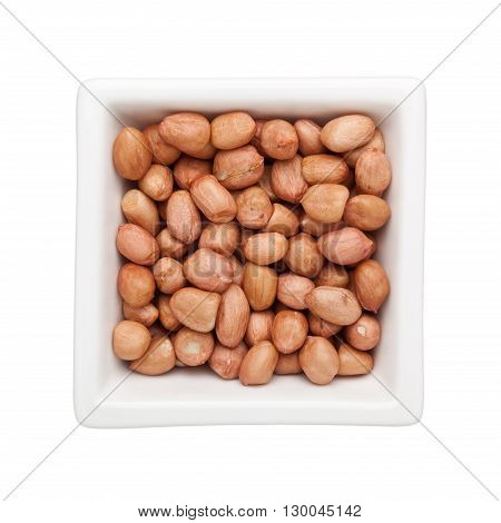 Shelled peanuts in a square bowl isolated on white background