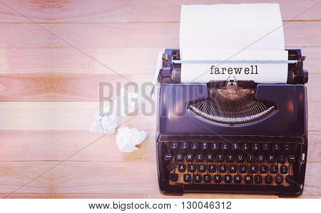 Farewell message on a white background against typewriter with paper on table in office