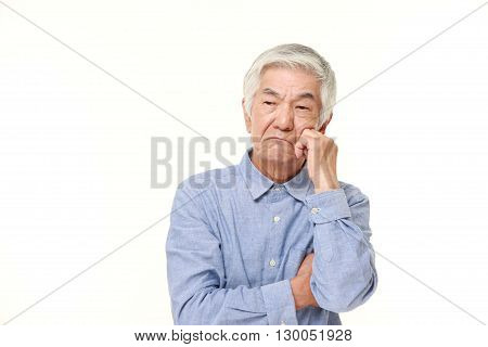 portrait of senior Japanese man worries about something on white background